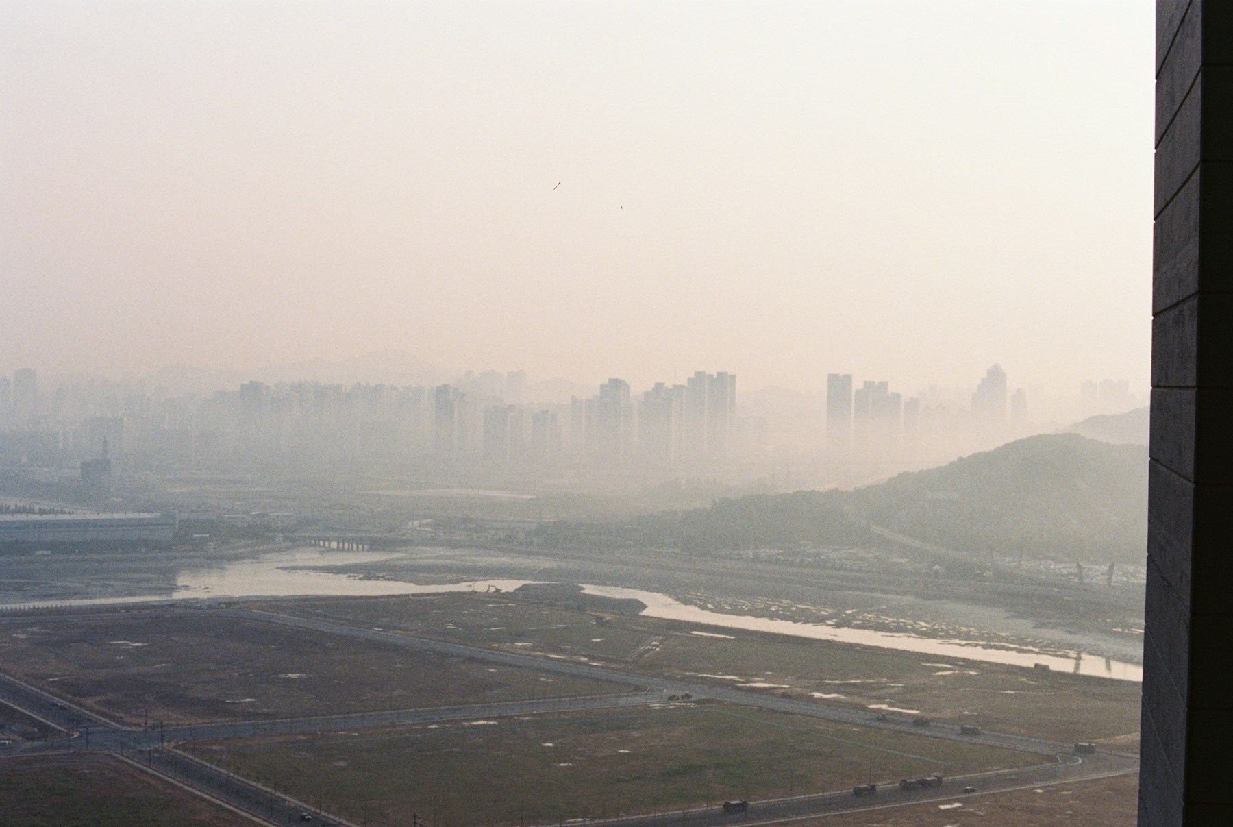 City skyline softened by haze on a misty day.